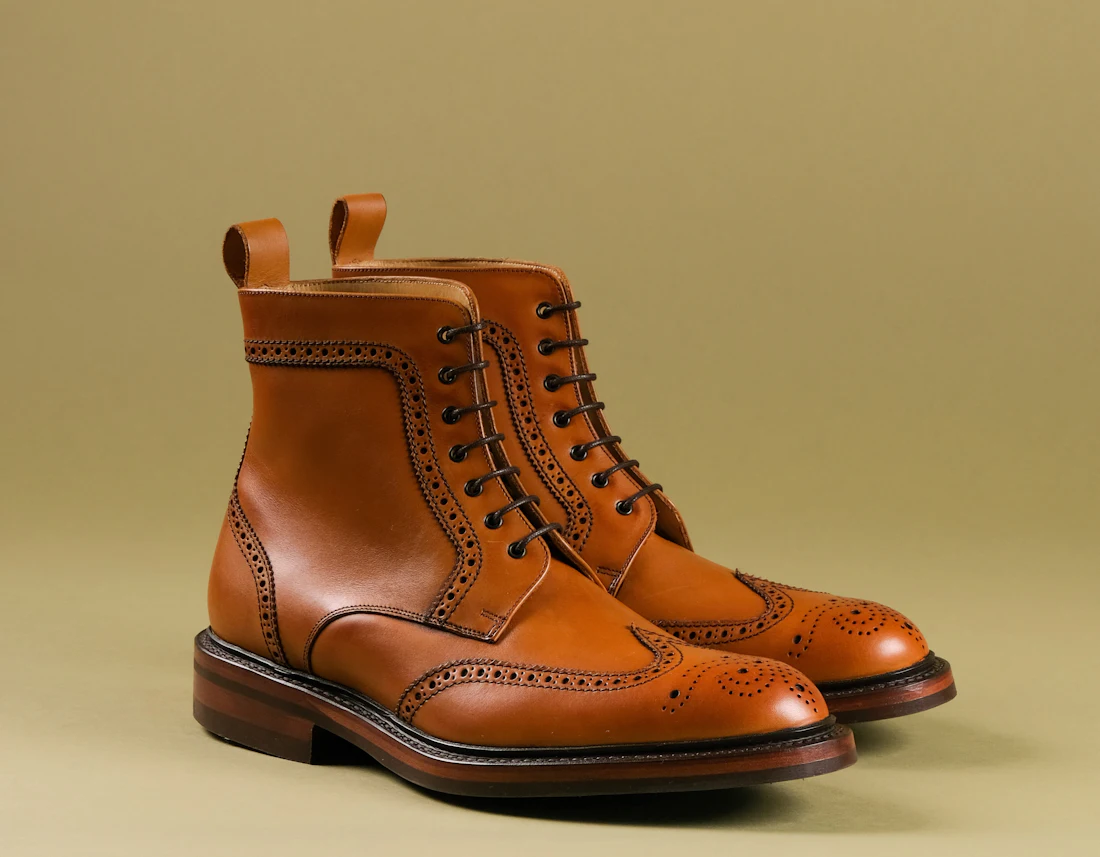 A pair of brown leather brogue boots