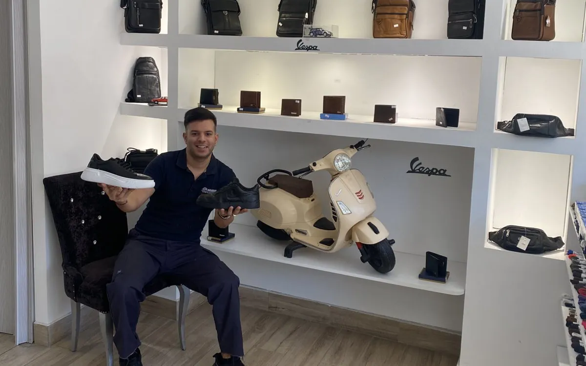 Inside Doctor Shoes in Nikaia with Thodoris, bags and wallets on the shelves